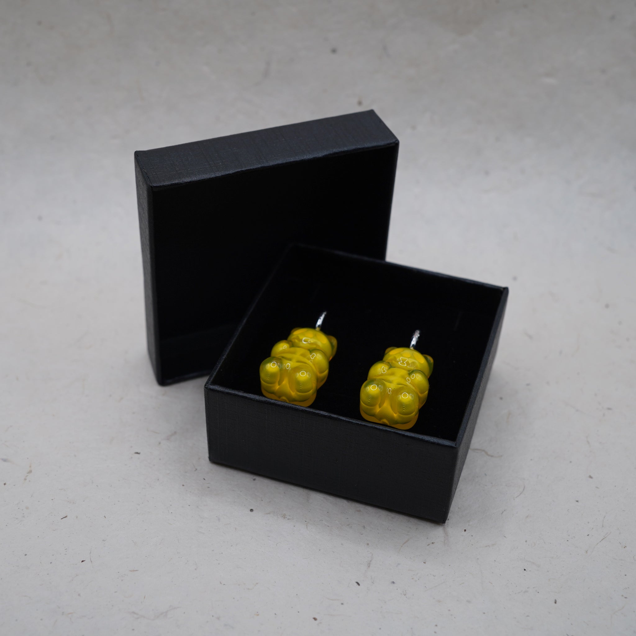 Yellow gummy bear skeleton earrings presented in black gift box, transparent resin handmade jewelry ready for gifting