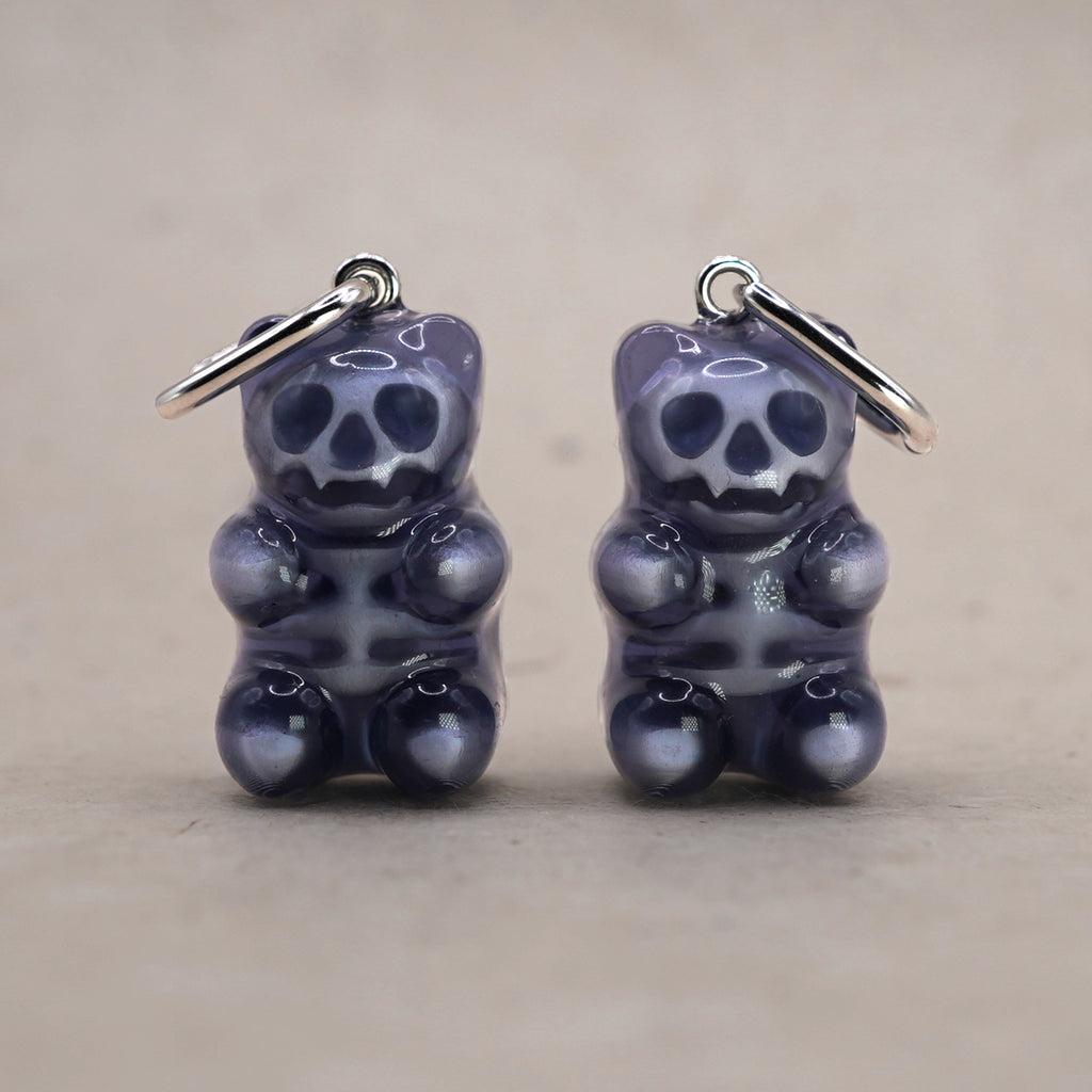 Transparent gummy bear skeleton earrings made of glossy resin, gothic candy-inspired jewelry with visible skull and bones