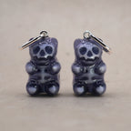 Transparent gummy bear skeleton earrings made of glossy resin, gothic candy-inspired jewelry with visible skull and bones