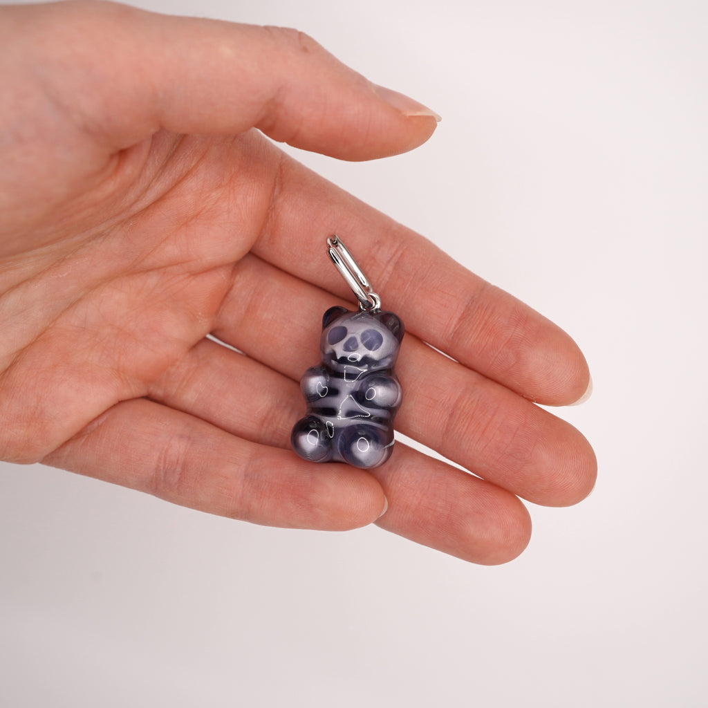 Front view of clear gummy bear skeleton earrings with skull face, glossy resin candy bear jewelry, spooky cute gothic accessory