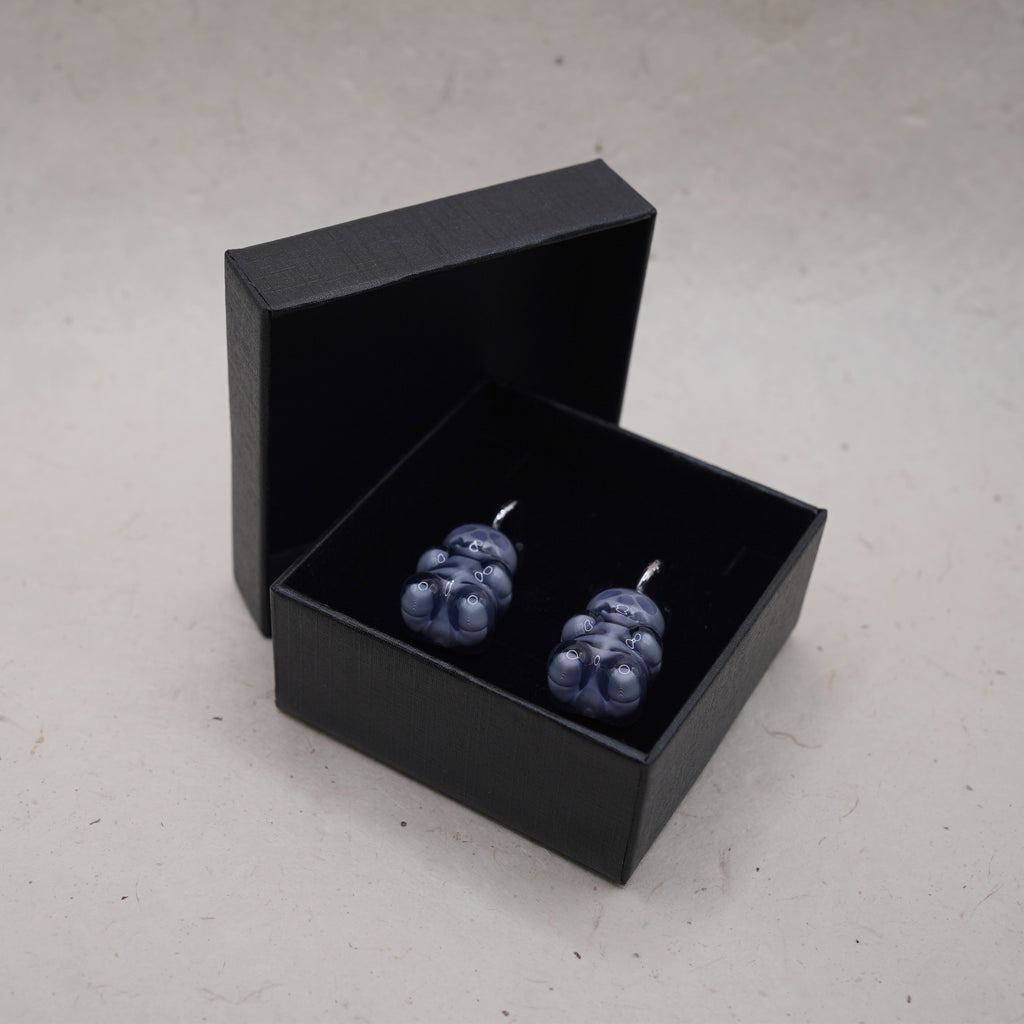 Dark transparent gummy bear skeleton earrings displayed in black gift box, glossy resin gothic handmade jewelry