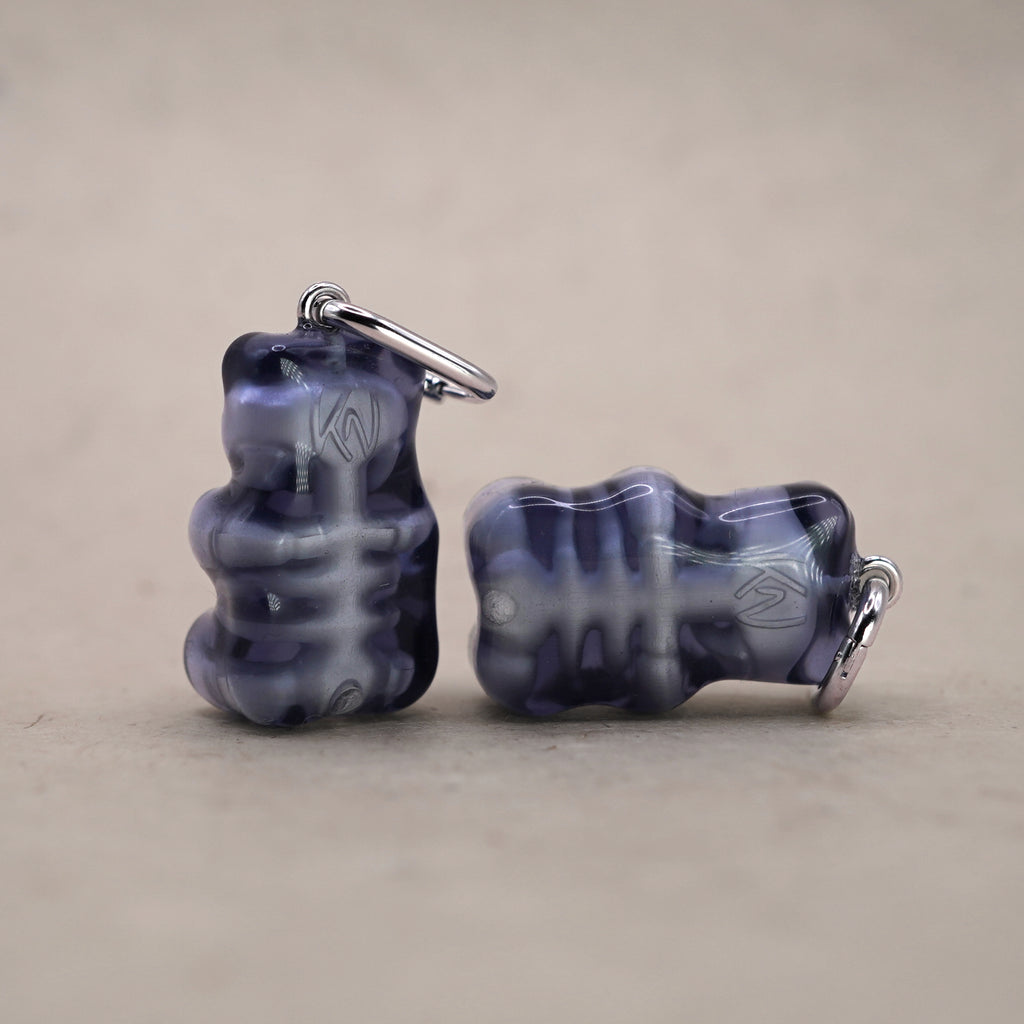 Back view of transparent gummy bear earrings revealing internal skeleton, dark resin skull bear jewelry, handmade alternative gothic earrings