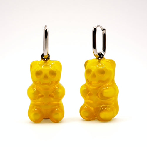 Yellow transparent gummy bear skeleton earrings front view, handmade resin jewelry with spooky cute style