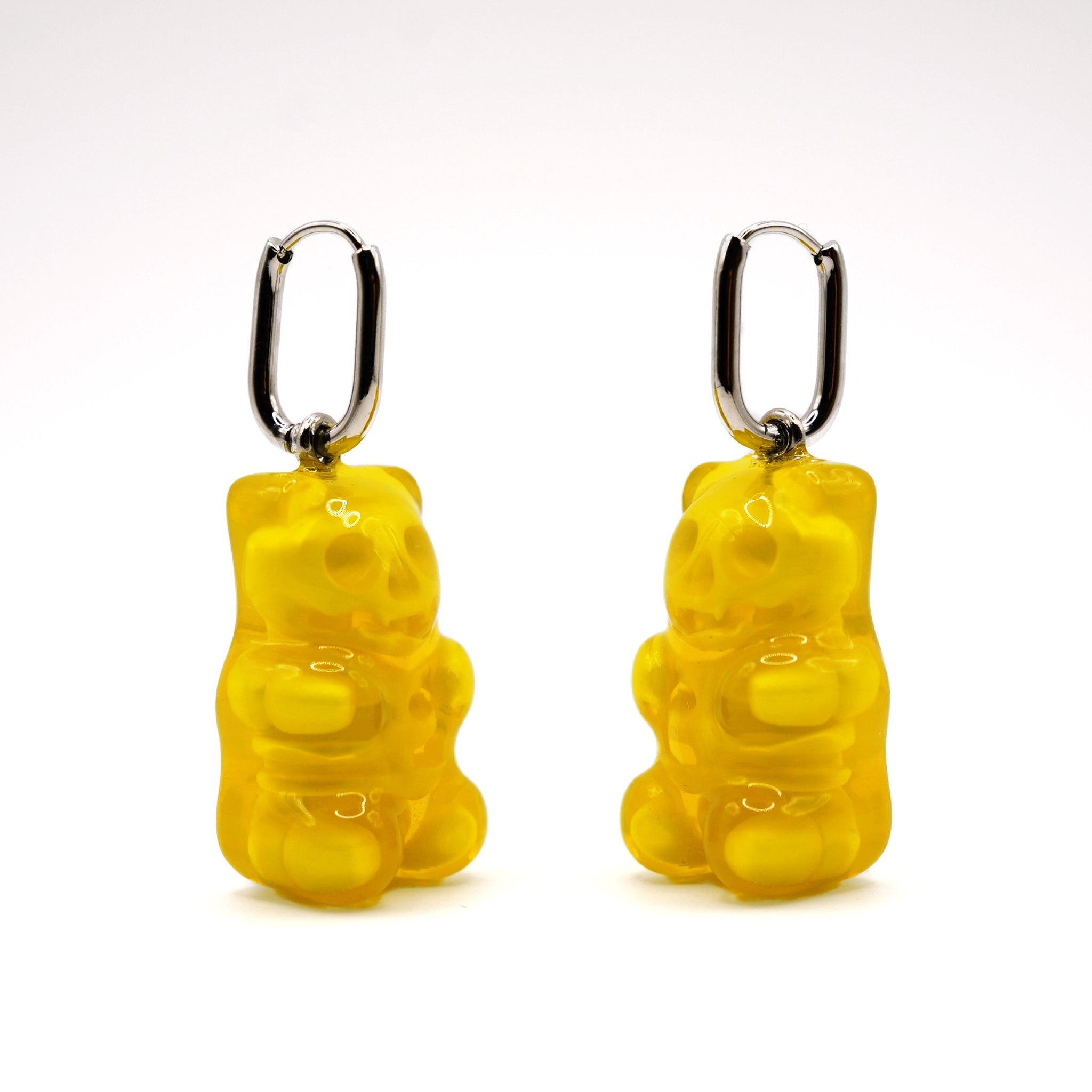 Pair of yellow translucent gummy bear skeleton earrings, glossy resin candy-inspired gothic jewelry