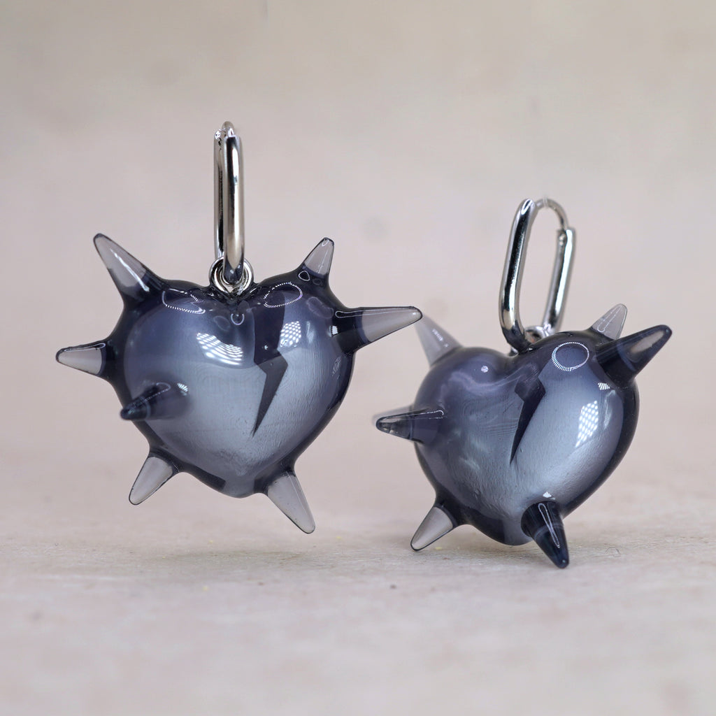 Pair of dark translucent spiked heart earrings in glossy resin, gothic handmade jewelry with sharp heart design