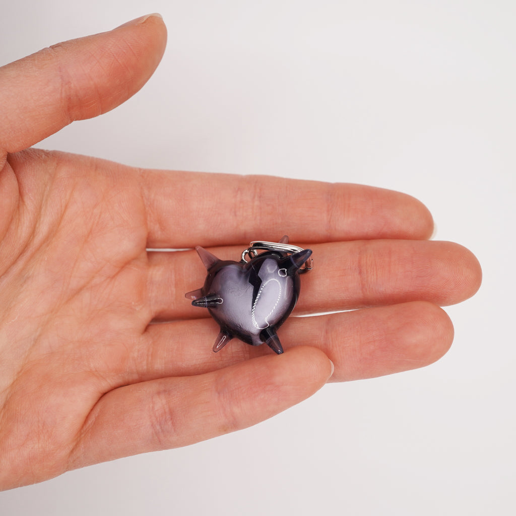 Pair of spiked heart resin earrings with visible cracked heart detail, alternative gothic jewelry aesthetic