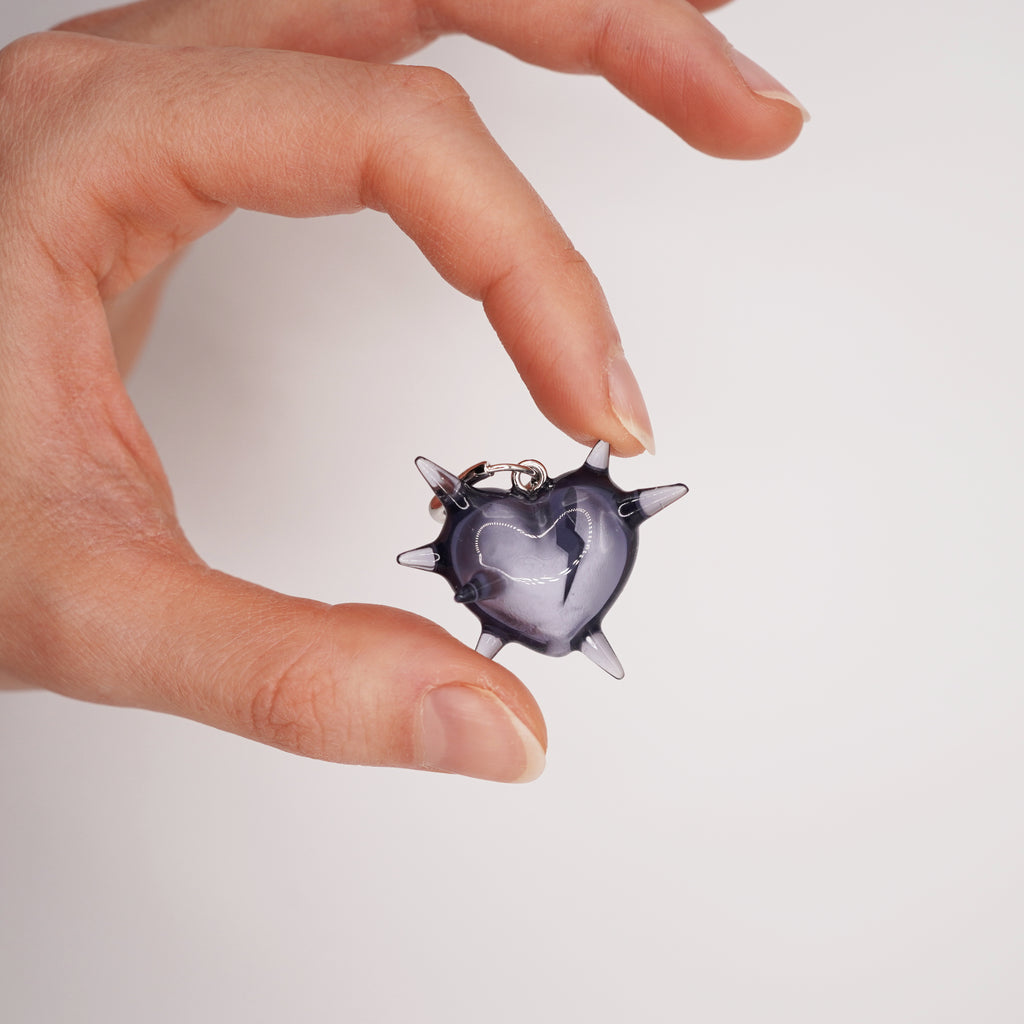 Spiked broken heart earring worn on ear, translucent resin gothic jewelry with dark romantic symbolism