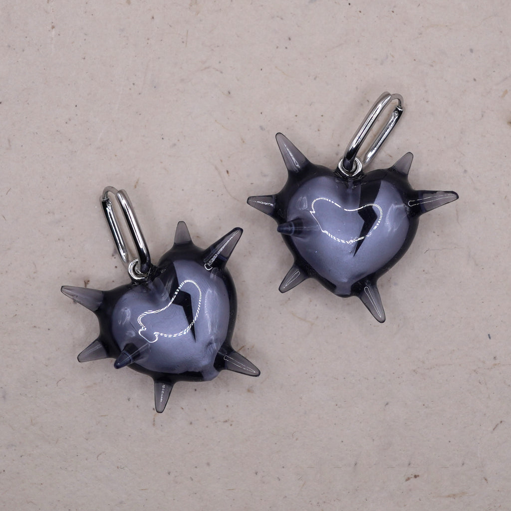 Transparent spiked heart earrings in glossy resin with broken heart detail, gothic handmade jewelry on silver hoops