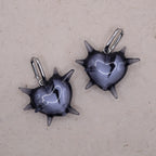 Transparent spiked heart earrings in glossy resin with broken heart detail, gothic handmade jewelry on silver hoops